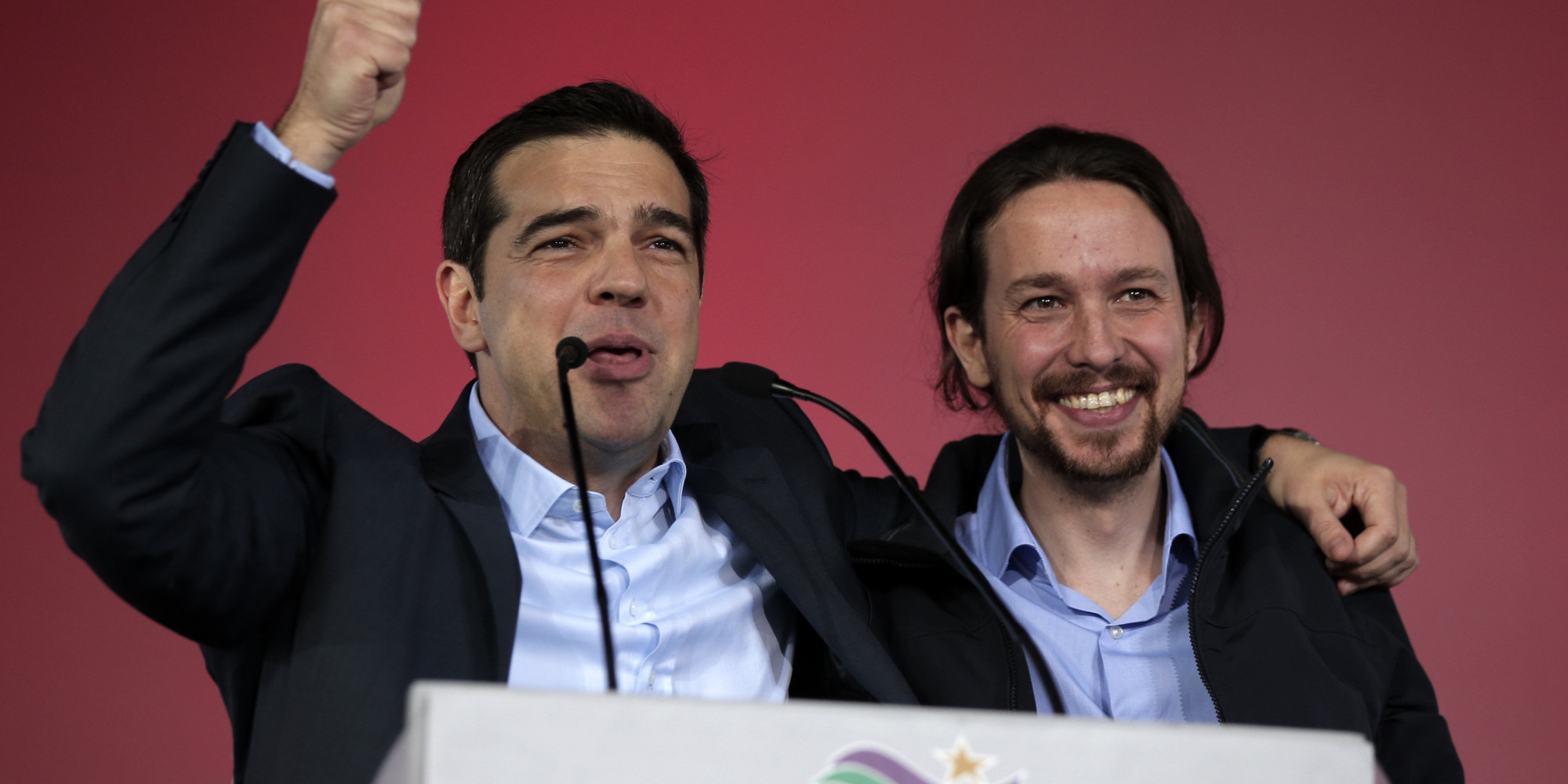 Alexis Tsipras, leader of Greece's Syriza left-wing main opposition party, left, puts his arm around the shoulder of Pablo Iglesias leader of Spanish Podemos left-wing party after a pre-election speech at Omonia Square in Athens on Thursday, Jan. 22, 2015. Prime Minister Antonis Samaras' New Democracy party has failed so far to overcome a gap in opinion polls with the anti-bailout Syriza party ahead of the Jan. 25 general election. (AP Photo/Lefteris Pitarakis)